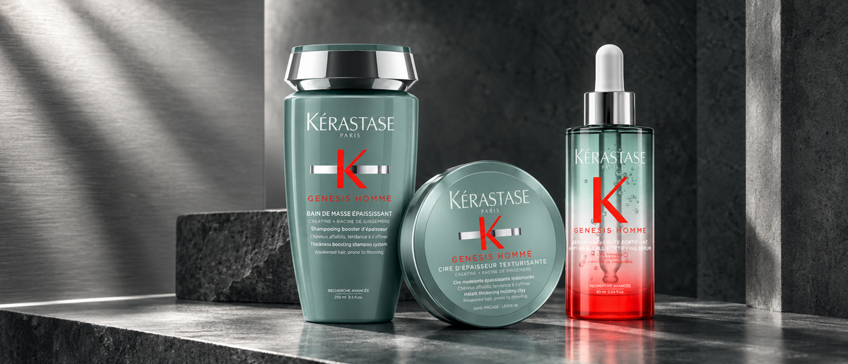 Kérastase Genesis Homme shampoo, serum and styling clay on charcoal stone with brushed silver.